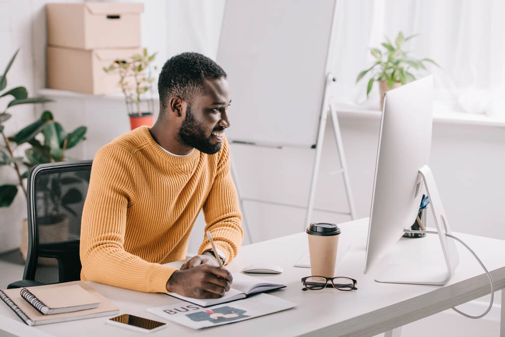 Feature image of a man working in front of a PC.