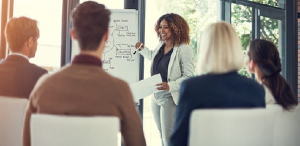 Shes got some exciting ideas for the future of business. a businesswoman giving a presentation to her colleagues in the boardroom
