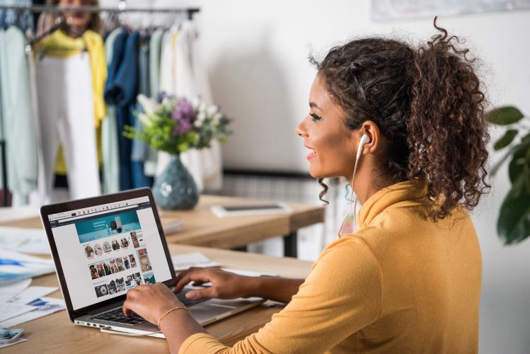 Young woman sitting at a laptop.