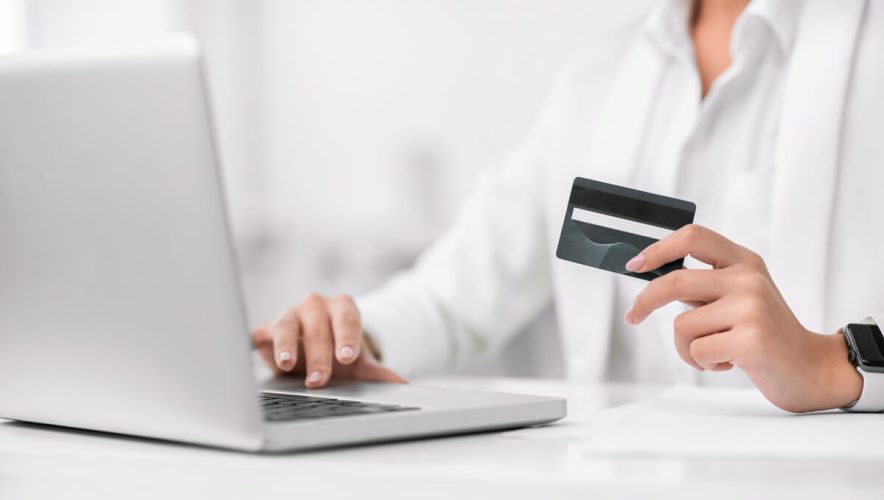 A donor makes an online donation using a credit card and a laptop